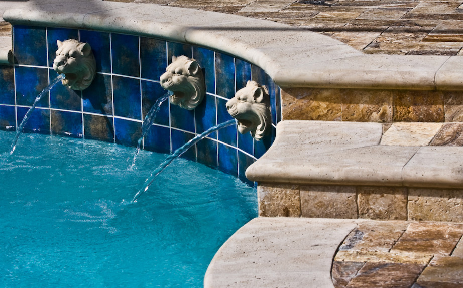 Inspiration for a mid-sized mediterranean backyard round lap pool in Other with natural stone pavers.