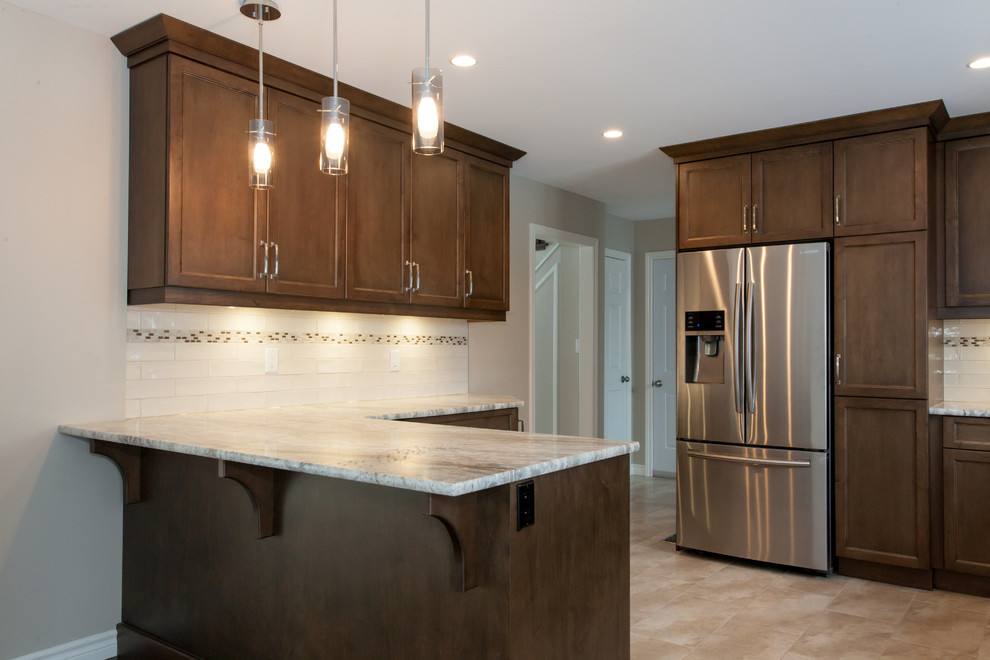 Inspiration for a mid-sized transitional u-shaped porcelain tile eat-in kitchen remodel in Toronto with an undermount sink, recessed-panel cabinets, dark wood cabinets, granite countertops, white backsplash, porcelain backsplash, stainless steel appliances and a peninsula