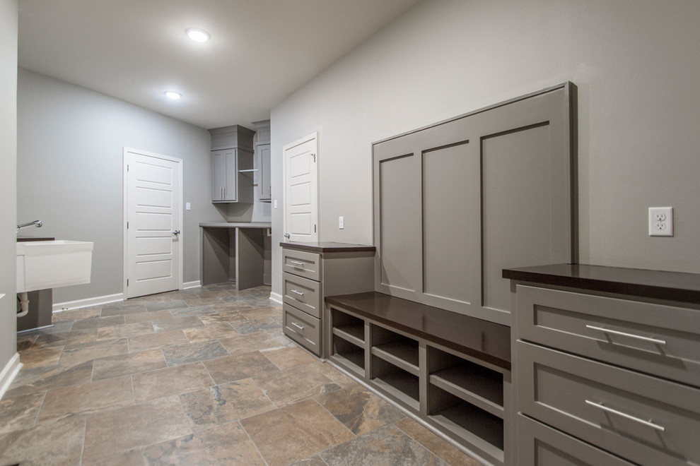 Design ideas for a mid-sized traditional laundry room in Little Rock with shaker cabinets, grey cabinets, grey walls and slate floors.