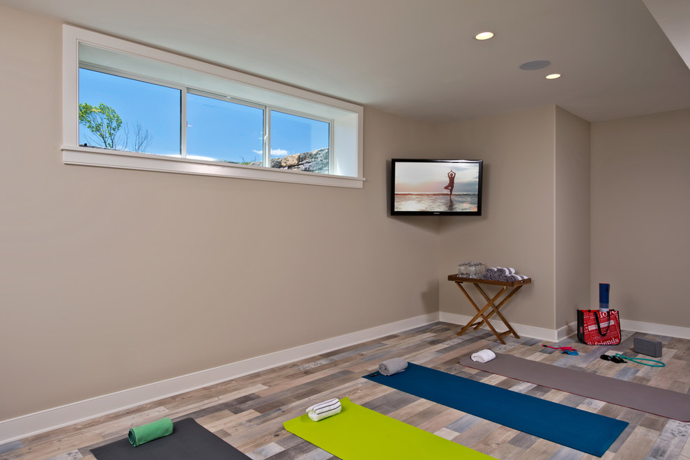 Design ideas for a transitional multipurpose gym in New York with beige walls and laminate floors.