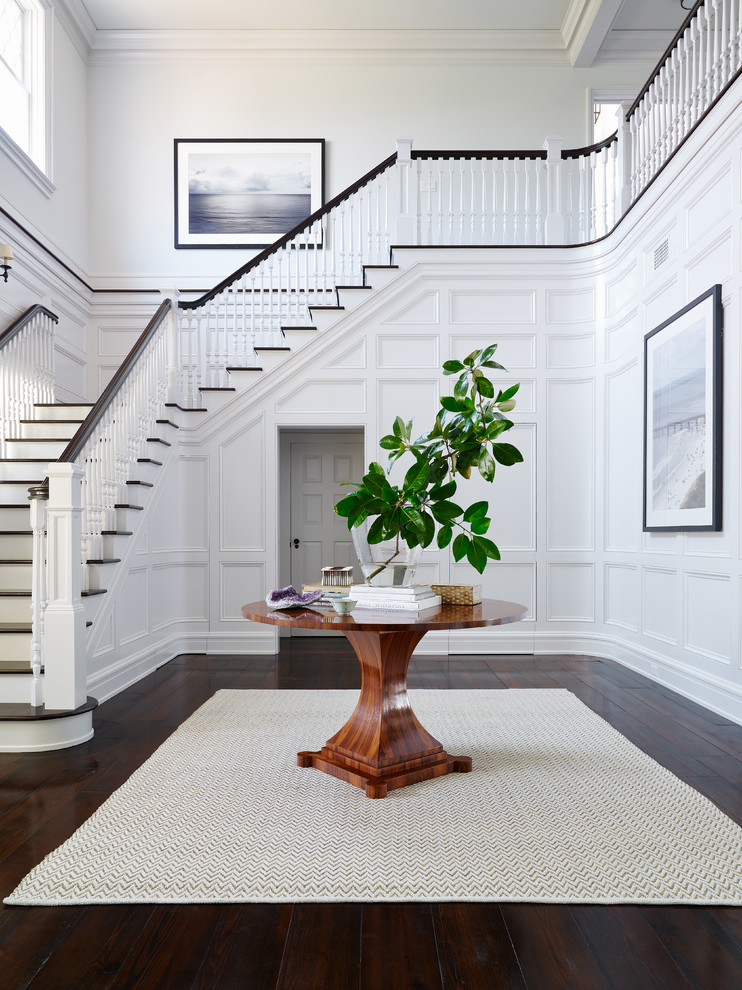 Design ideas for a traditional foyer in Jacksonville with white walls and dark hardwood floors.