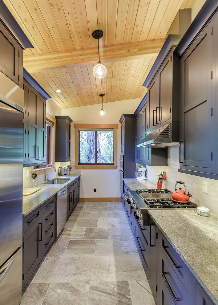 Mid-sized contemporary galley eat-in kitchen in Seattle with a single-bowl sink, recessed-panel cabinets, black cabinets, granite benchtops, beige splashback, ceramic splashback, stainless steel appliances, porcelain floors and no island.