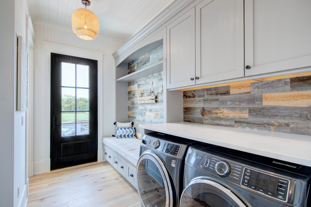 Example of a large cottage single-wall wood ceiling dedicated laundry room design in Other with shaker cabinets, gray cabinets, quartzite countertops, wood backsplash, a side-by-side washer/dryer and white countertops