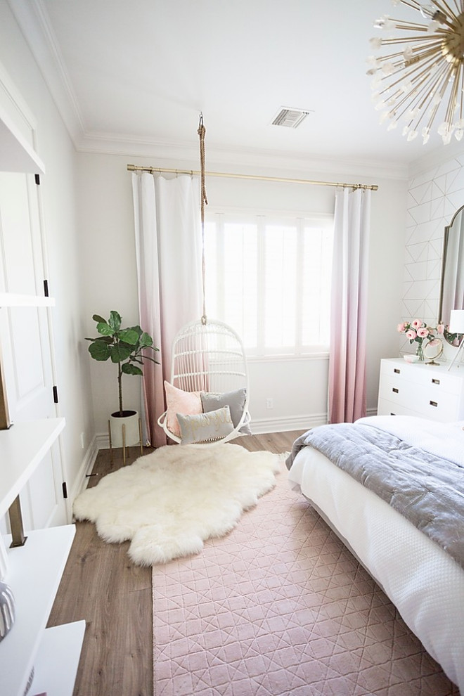 Photo of a mid-sized transitional kids' room for girls in Phoenix with white walls and brown floor.