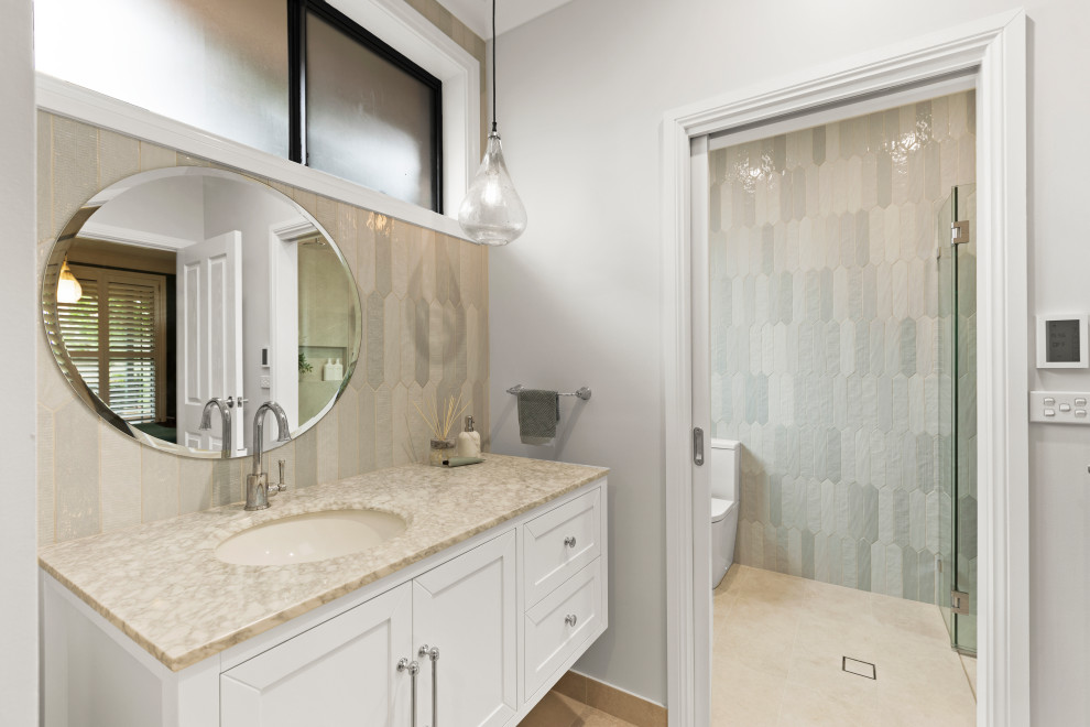 Medium sized classic shower room bathroom in Sydney with shaker cabinets, white cabinets, a double shower, a two-piece toilet, grey tiles, a submerged sink, a hinged door, a wall niche, a single sink and a floating vanity unit.