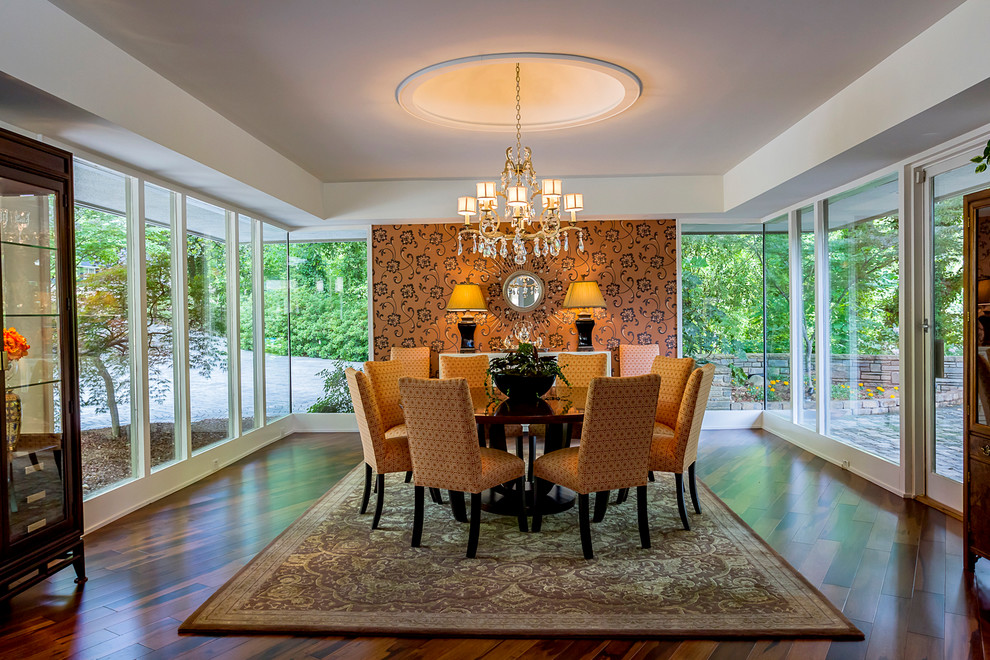 This is an example of an expansive midcentury separate dining room in Charlotte with dark hardwood floors, white walls and brown floor.