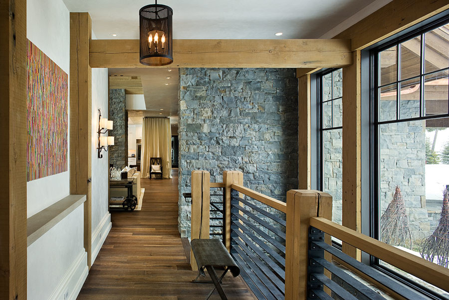 Photo of a large contemporary hallway in Other with white walls, dark hardwood floors and brown floor.