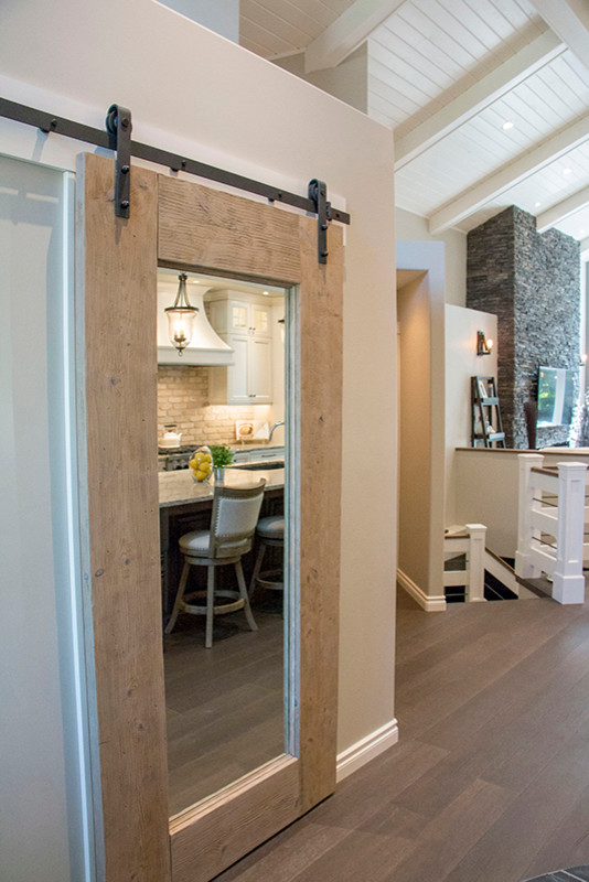Eat-in kitchen - large transitional l-shaped eat-in kitchen idea with a double-bowl sink, shaker cabinets, white cabinets, beige backsplash, stainless steel appliances and an island