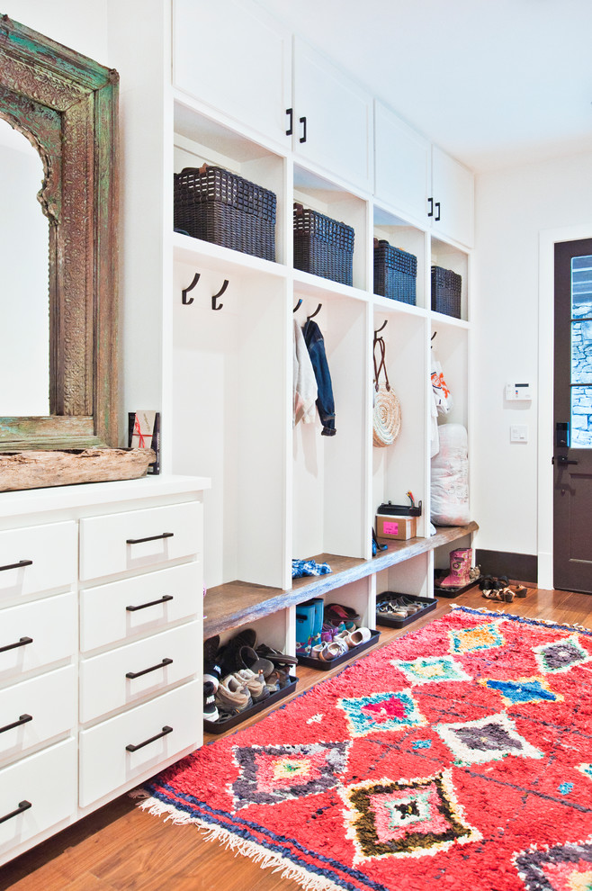 Large transitional light wood floor and brown floor mudroom photo in Nashville with white walls and a dark wood front door