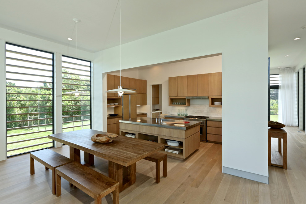 Inspiration for a contemporary kitchen/dining combo in New York with white walls and light hardwood floors.