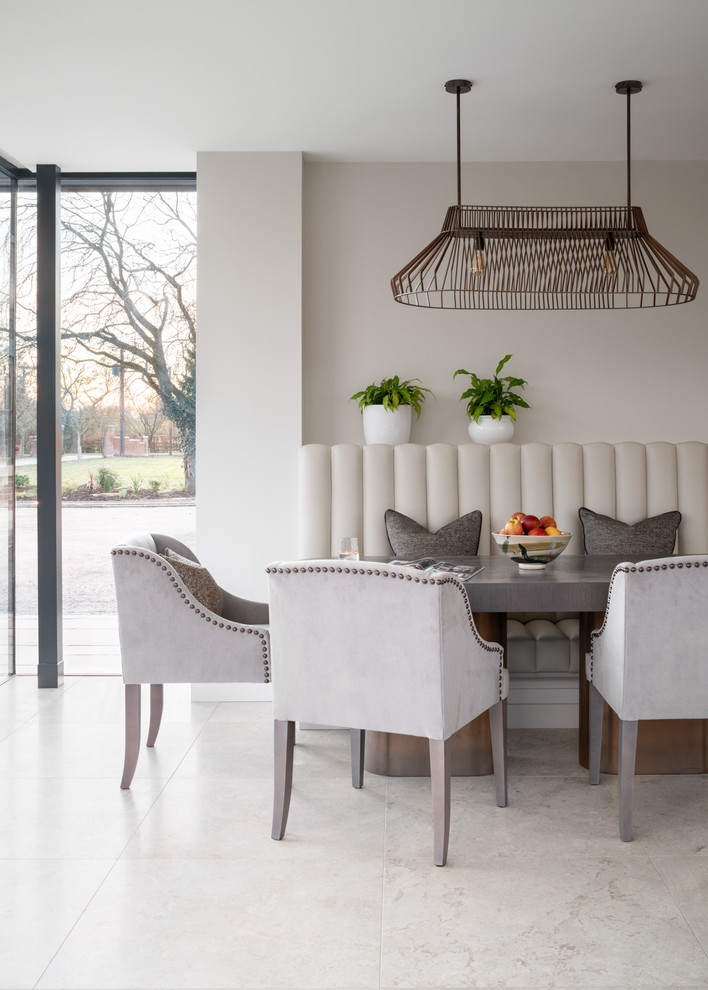 Photo of a large contemporary open plan dining in London with grey walls, limestone floors and white floor.