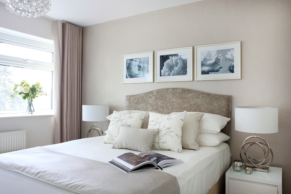Mid-sized transitional bedroom in London with beige walls.