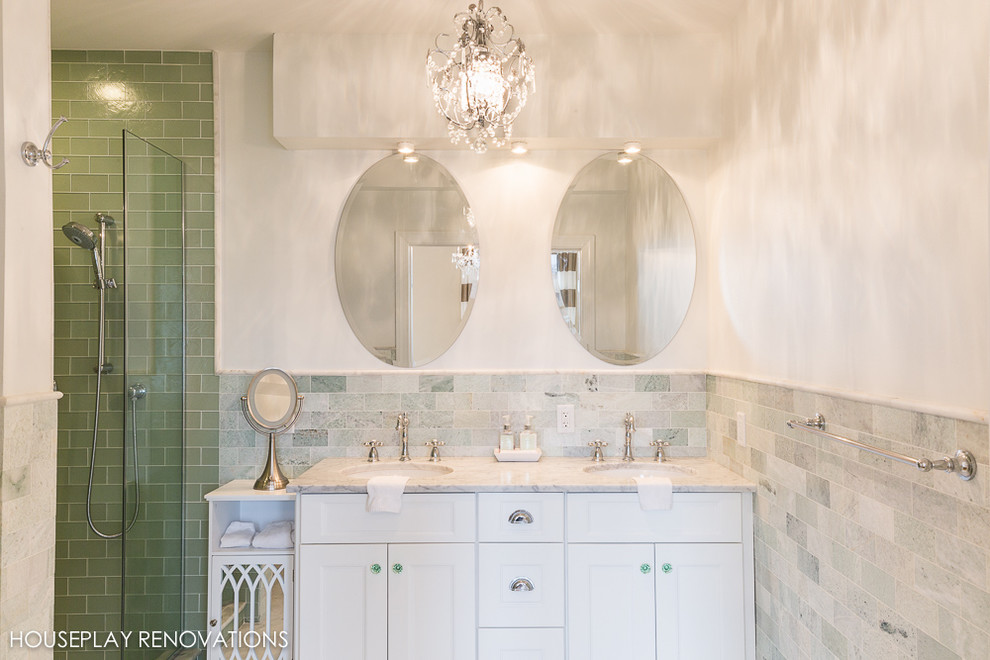 Photo of a mid-sized contemporary master bathroom in New York with an alcove shower, shaker cabinets, white cabinets, a two-piece toilet, green tile, subway tile, white walls, marble floors, an undermount sink and marble benchtops.