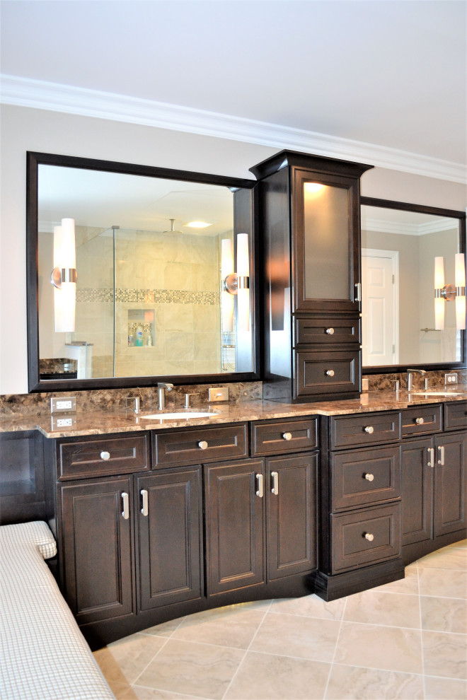 Inspiration for a large transitional master bathroom with raised-panel cabinets, dark wood cabinets, a double shower, a two-piece toilet, beige tile, stone tile, beige walls, porcelain floors, marble benchtops and an undermount sink.