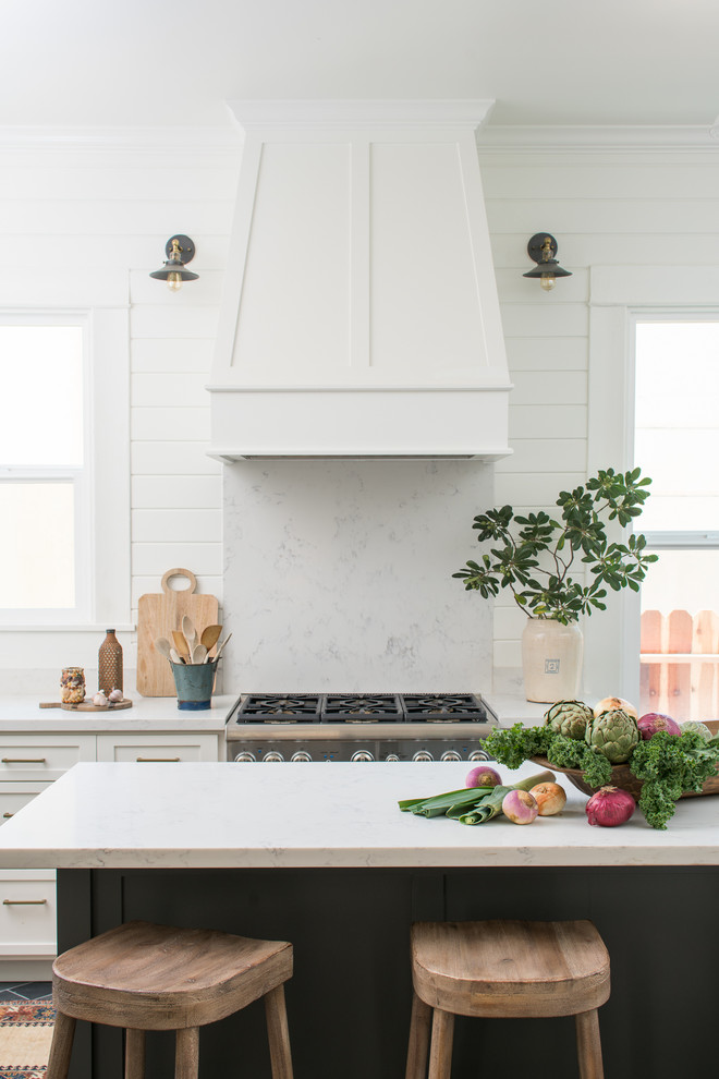 Inspiration for a mid-sized victorian l-shaped slate floor and gray floor kitchen remodel in Sacramento with a farmhouse sink, shaker cabinets, white cabinets, quartzite countertops, stone slab backsplash, stainless steel appliances and an island