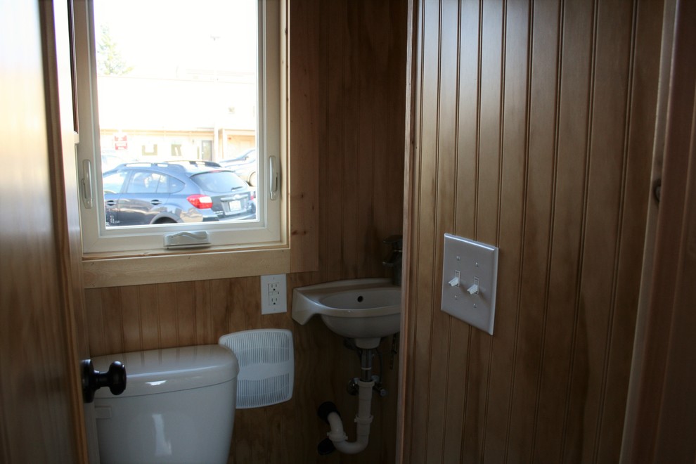 Inspiration for a small rustic 3/4 dark wood floor alcove shower remodel in Seattle with a wall-mount sink, a two-piece toilet and brown walls
