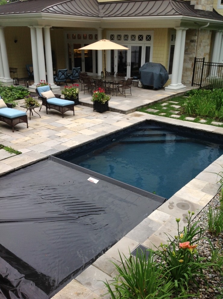 Small traditional backyard rectangular lap pool in Other with a hot tub and concrete pavers.