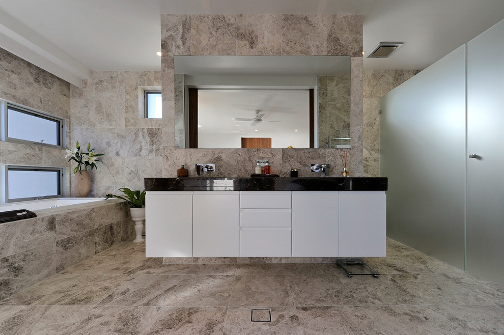 Modern master bathroom in Newcastle - Maitland with an undermount sink, white cabinets, marble benchtops, a drop-in tub, an open shower, stone tile and travertine floors.