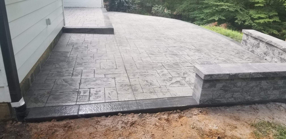 Mid-sized traditional backyard patio in Other with stamped concrete.