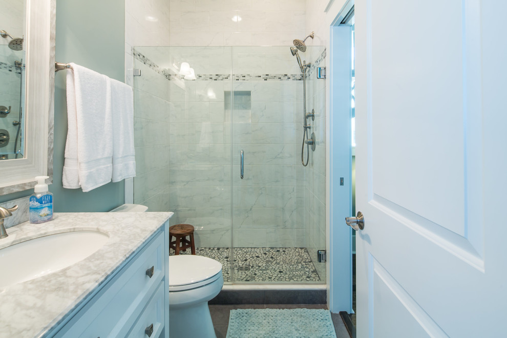 This is an example of a mid-sized traditional 3/4 bathroom in Miami with recessed-panel cabinets, white cabinets, an alcove shower, white tile, marble, green walls, an undermount sink and marble benchtops.