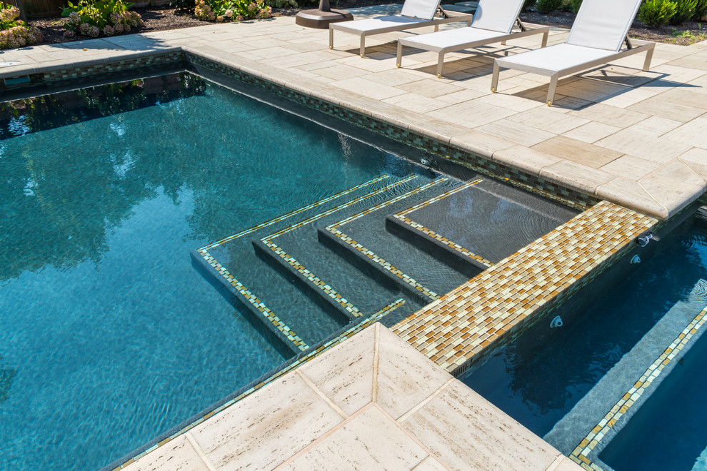 Mid-sized modern indoor rectangular pool in New York with brick pavers.