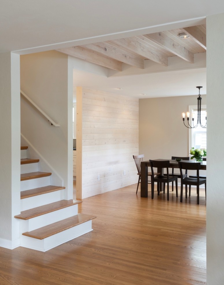 This is an example of a mid-sized transitional entry hall in Seattle with beige walls, light hardwood floors, a single front door and a light wood front door.