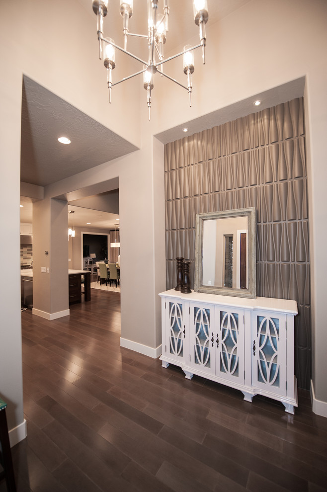 This is an example of a mid-sized contemporary foyer in Salt Lake City with grey walls, dark hardwood floors and brown floor.