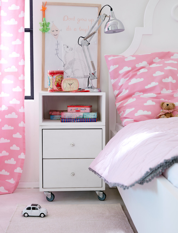 Photo of a contemporary kids' room for girls in Hamburg with grey walls and light hardwood floors.