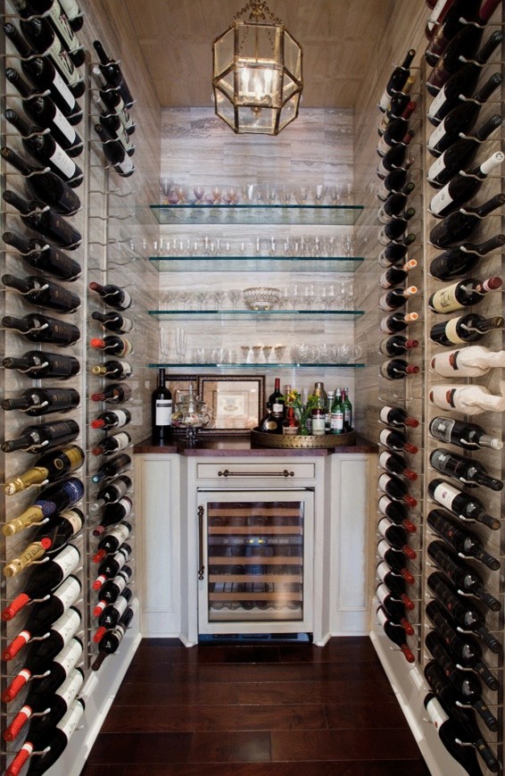 Large transitional walk-out dark wood floor wine cellar photo in Denver with beige walls, a ribbon fireplace and a metal fireplace