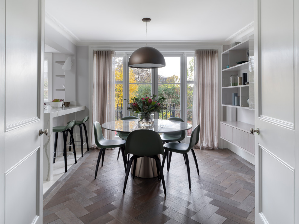 Design ideas for a mid-sized contemporary open plan dining in London with medium hardwood floors and grey floor.