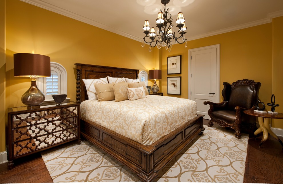 Inspiration for a large mediterranean bedroom in Other with yellow walls, dark hardwood floors and brown floor.