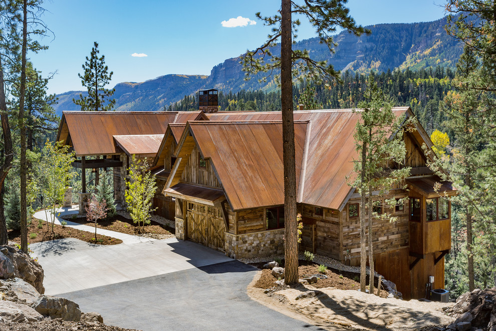 Inspiration for a large rustic brown two-story mixed siding house exterior remodel with a metal roof