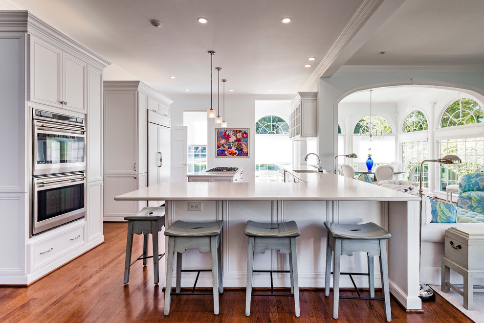 Large transitional u-shaped medium tone wood floor eat-in kitchen photo with an undermount sink, beaded inset cabinets, white cabinets, marble countertops, paneled appliances and an island