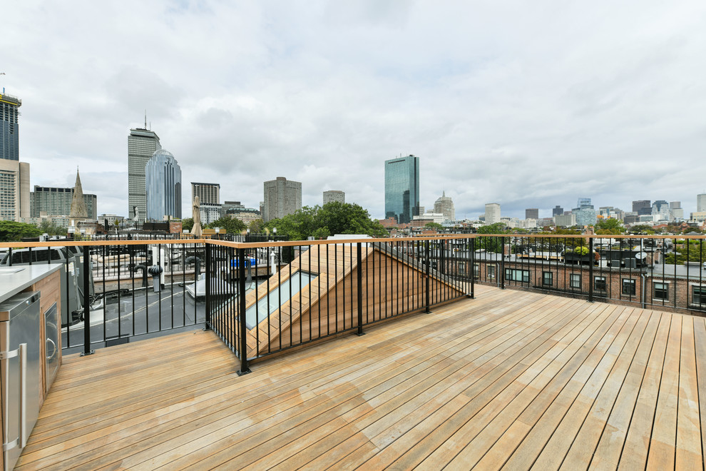 Photo of a large contemporary rooftop deck in Boston with an outdoor kitchen and no cover.