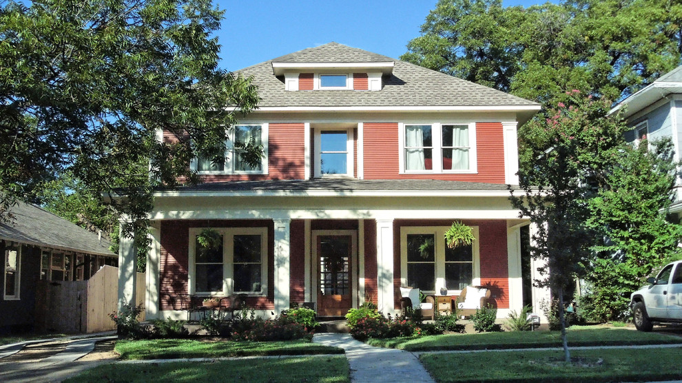 This is an example of a large arts and crafts two-storey red exterior in Dallas with wood siding.