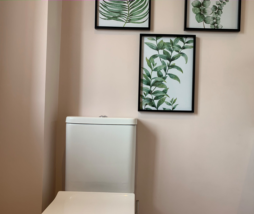 Photo of a small contemporary bathroom in Other with flat-panel cabinets, white cabinets, a one-piece toilet, pink walls, ceramic flooring, a vessel sink, solid surface worktops, white floors, white worktops, an enclosed toilet, a single sink and a freestanding vanity unit.