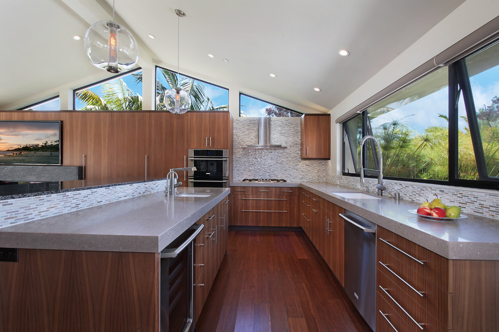 Photo of a contemporary l-shaped kitchen in Orange County with an undermount sink, flat-panel cabinets, medium wood cabinets, multi-coloured splashback, mosaic tile splashback, stainless steel appliances, medium hardwood floors and with island.