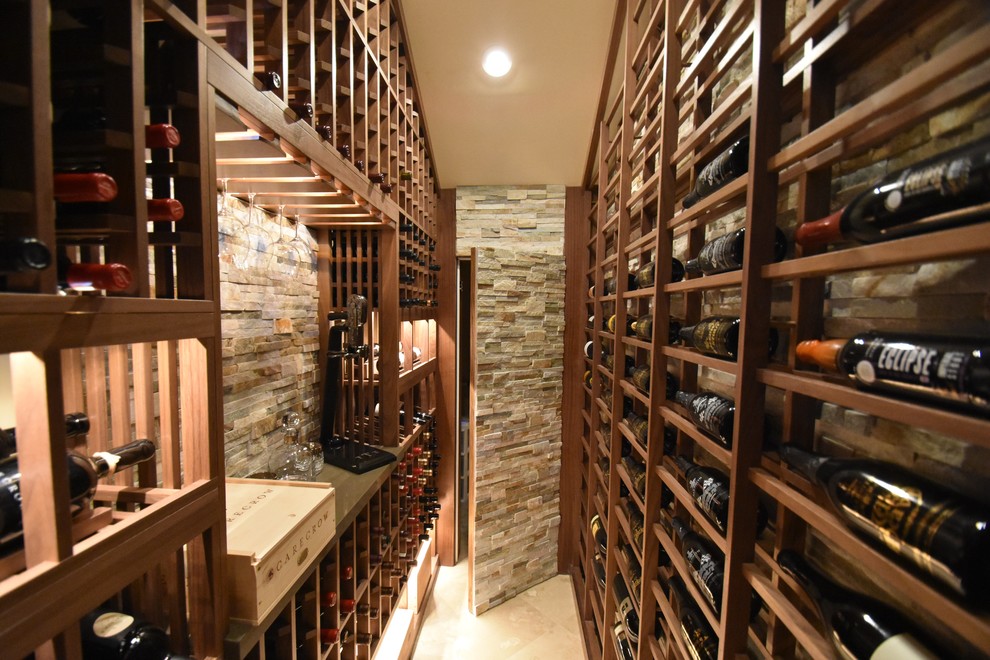 Mid-sized traditional wine cellar in Los Angeles with terra-cotta floors and display racks.