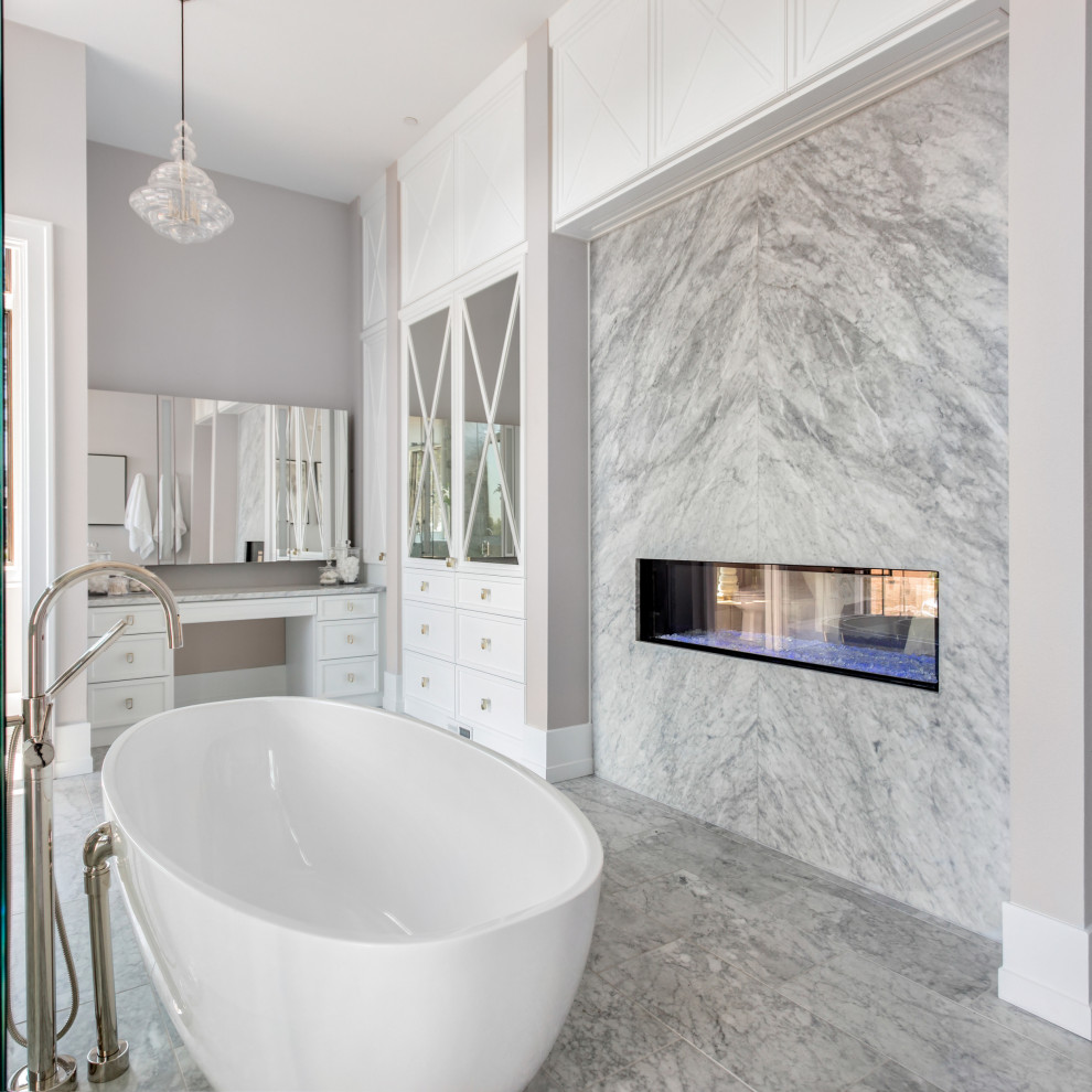 Expansive modern master bathroom in New York with furniture-like cabinets, white cabinets, a freestanding tub, a double shower, a bidet, gray tile, marble, white walls, marble floors, a drop-in sink, granite benchtops, grey floor, a hinged shower door, grey benchtops, a double vanity and a built-in vanity.