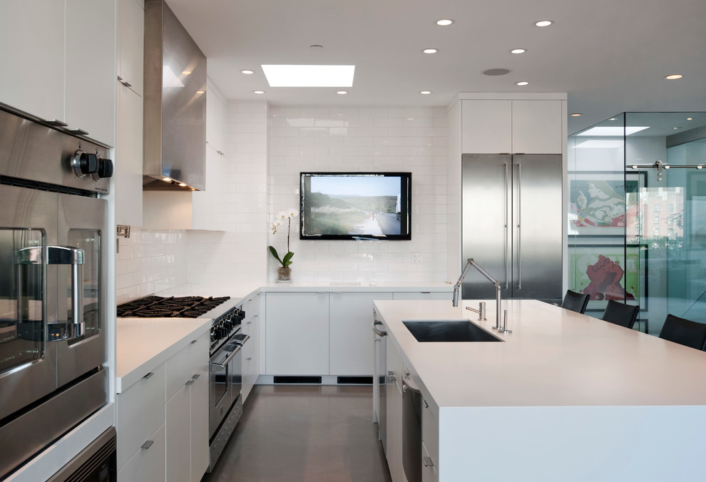 Contemporary l-shaped eat-in kitchen in Seattle with a single-bowl sink, open cabinets, white cabinets, solid surface benchtops, white splashback, ceramic splashback, stainless steel appliances, concrete floors and with island.