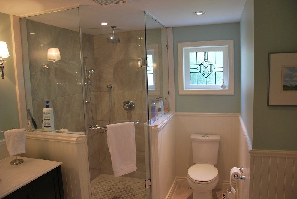 This is an example of a small traditional master bathroom in Toronto with an undermount sink, furniture-like cabinets, dark wood cabinets, engineered quartz benchtops, a corner shower, a two-piece toilet, beige tile, porcelain tile, blue walls and porcelain floors.