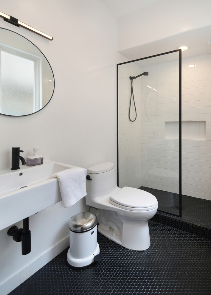 Inspiration for a small modern bathroom in Orange County with an open shower, a one-piece toilet, white tile, subway tile, white walls, mosaic tile floors, a wall-mount sink, black floor, an open shower and white benchtops.