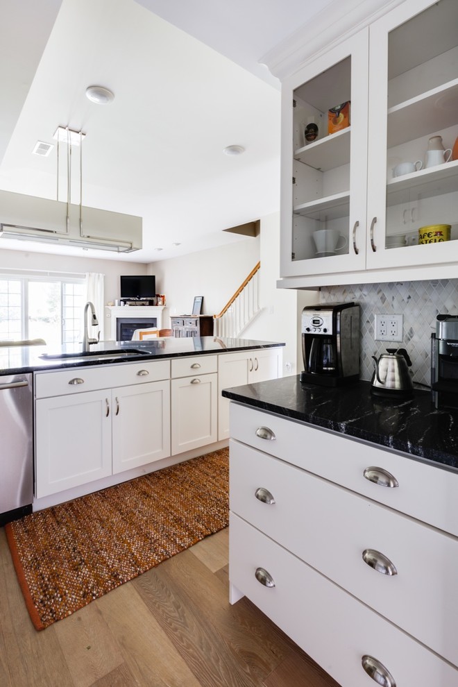 Inspiration for a small modern l-shaped open plan kitchen in Other with an undermount sink, shaker cabinets, white cabinets, granite benchtops, grey splashback, marble splashback, stainless steel appliances, medium hardwood floors and a peninsula.