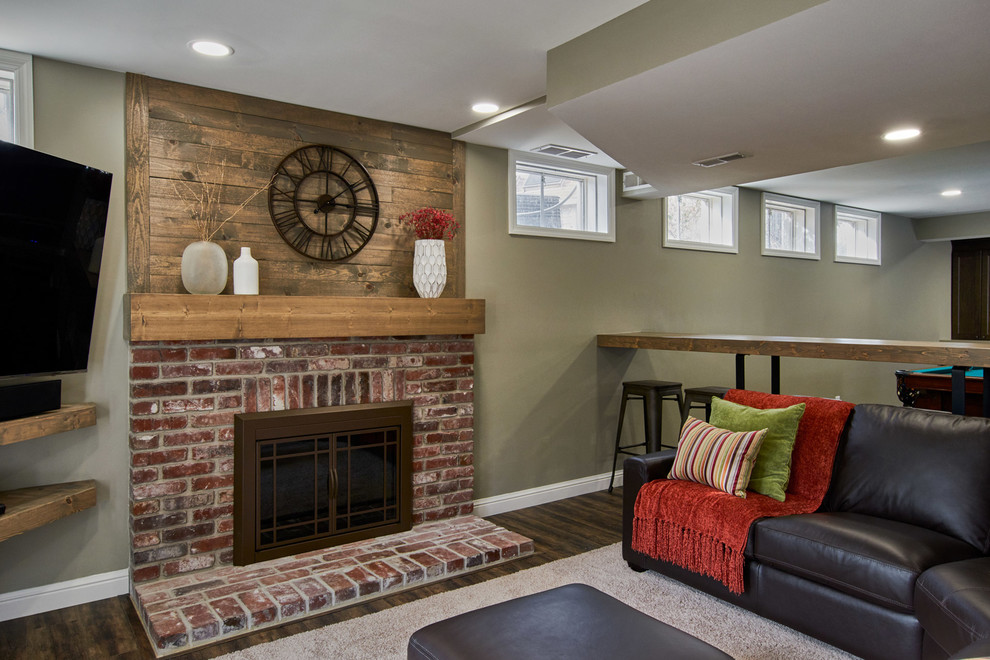 Inspiration for a large rustic walk-out vinyl floor and brown floor basement remodel in St Louis with gray walls and a standard fireplace