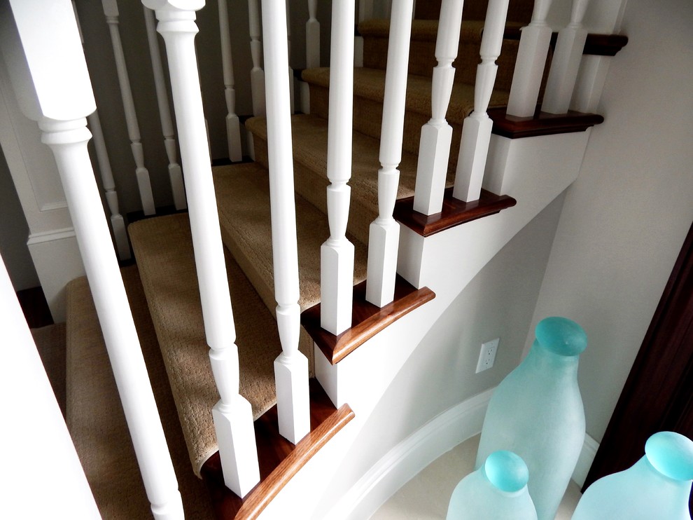 This is an example of a traditional wood staircase in Other with wood risers and wood railing.