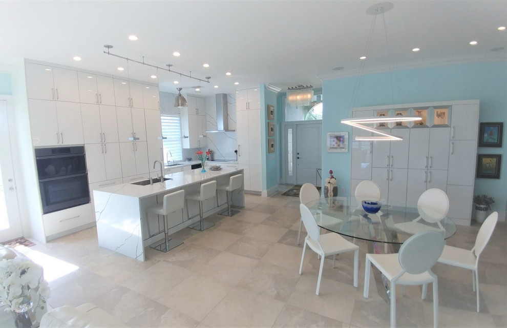 Photo of a modern l-shaped kitchen/diner in Other with a submerged sink, flat-panel cabinets, white cabinets, engineered stone countertops, white splashback, engineered quartz splashback, an island and white worktops.