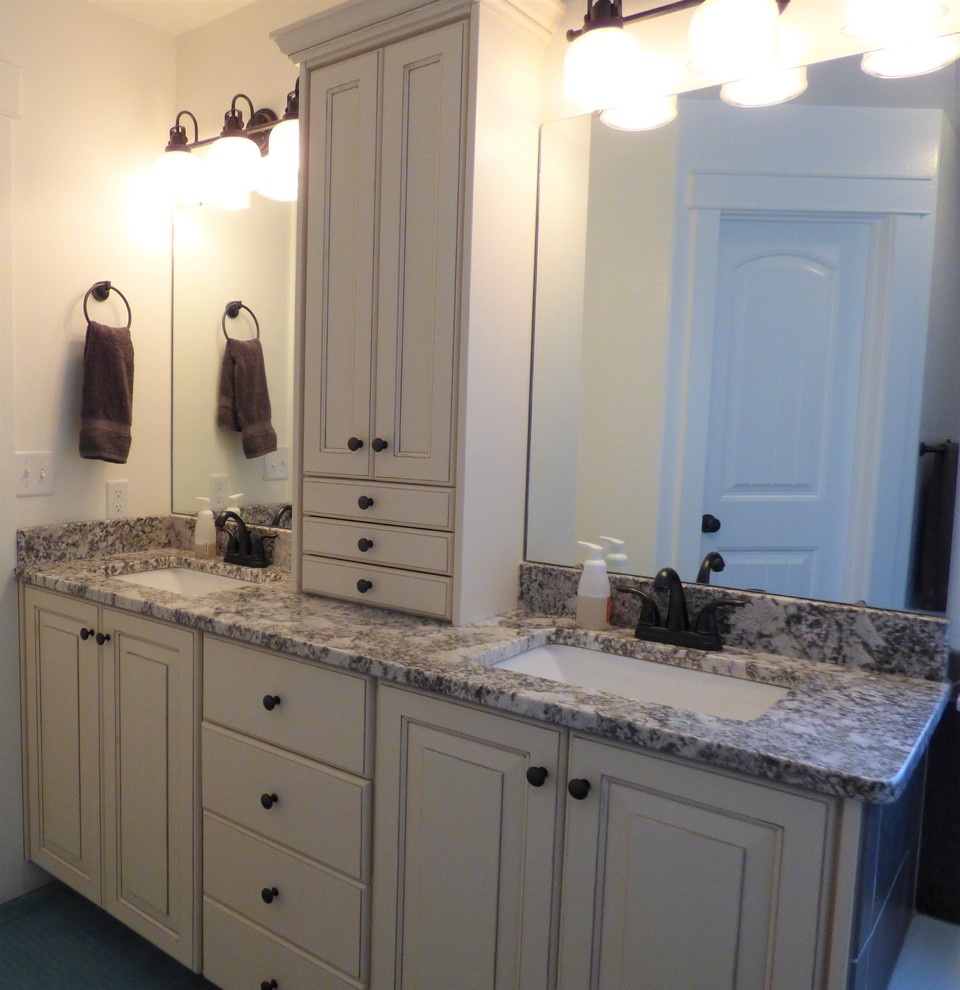 Photo of a mid-sized traditional master bathroom in Other with raised-panel cabinets, white cabinets, white walls, an undermount sink and granite benchtops.