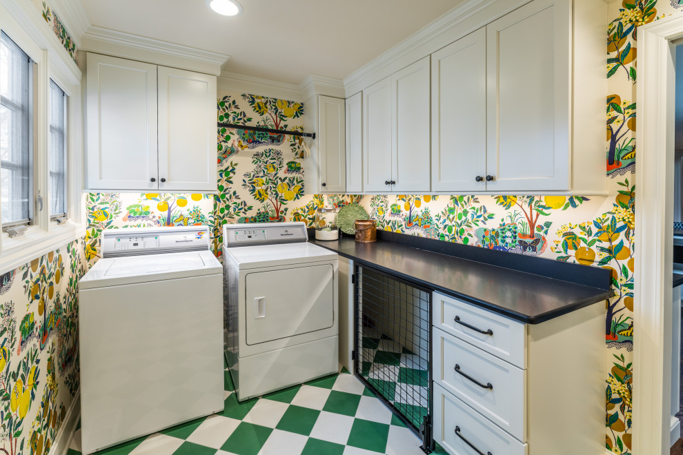 This is an example of a medium sized classic l-shaped utility room in Kansas City with a submerged sink, shaker cabinets, white cabinets, engineered stone countertops, multi-coloured walls, a side by side washer and dryer, green floors, black worktops and wallpapered walls.