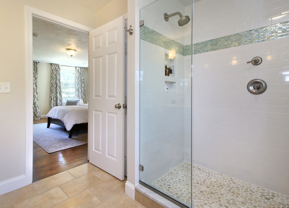 Example of a transitional master white tile and subway tile ceramic tile and beige floor double shower design in Portland Maine with raised-panel cabinets, dark wood cabinets, a two-piece toilet, beige walls, an integrated sink, solid surface countertops and a hinged shower door