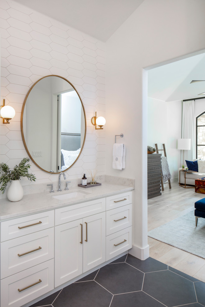 Example of a mid-sized transitional master white tile and ceramic tile porcelain tile and gray floor bathroom design in Austin with recessed-panel cabinets, white cabinets, a two-piece toilet, white walls, an undermount sink, marble countertops and white countertops